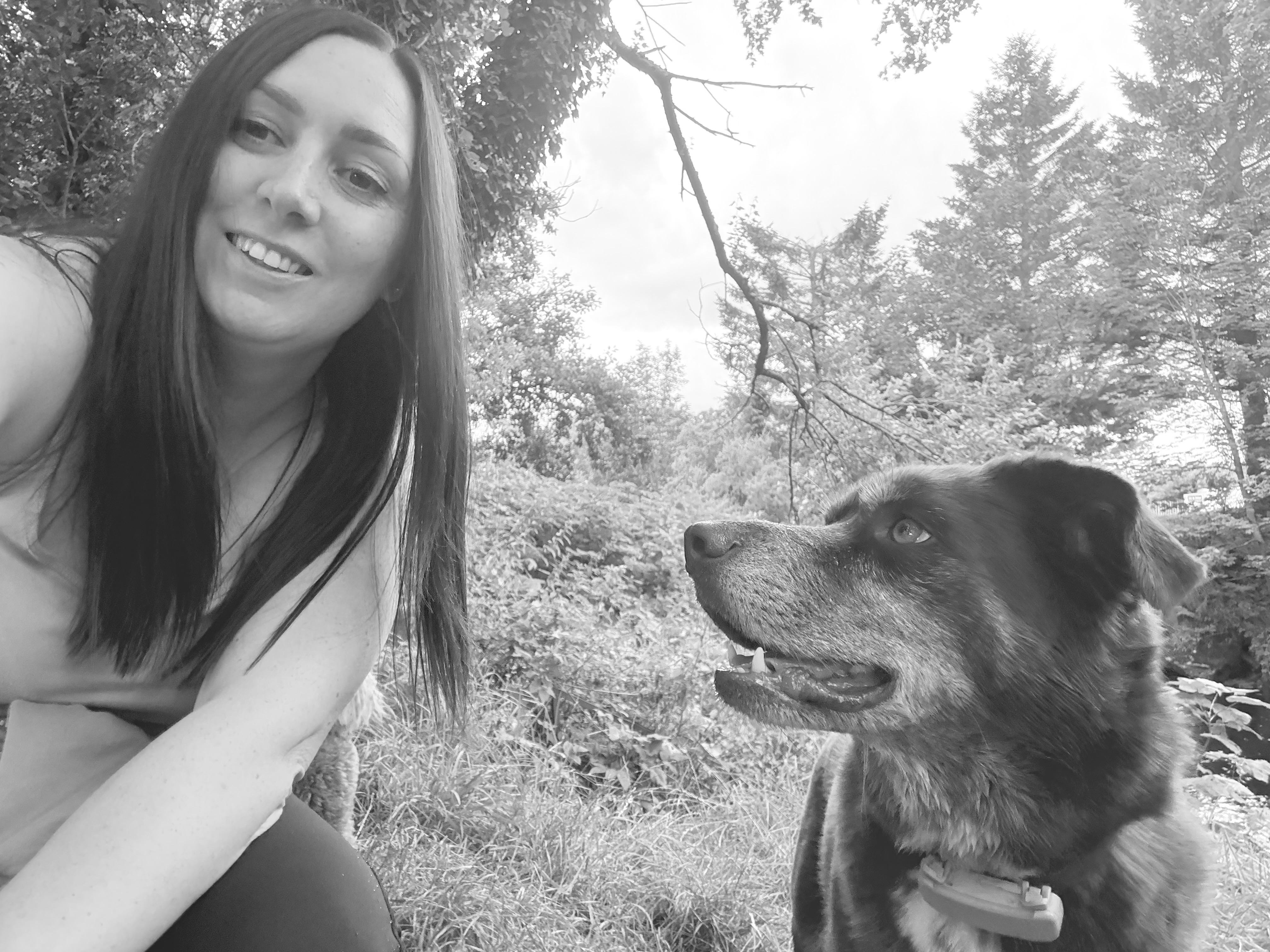 person and dog selfie in woods